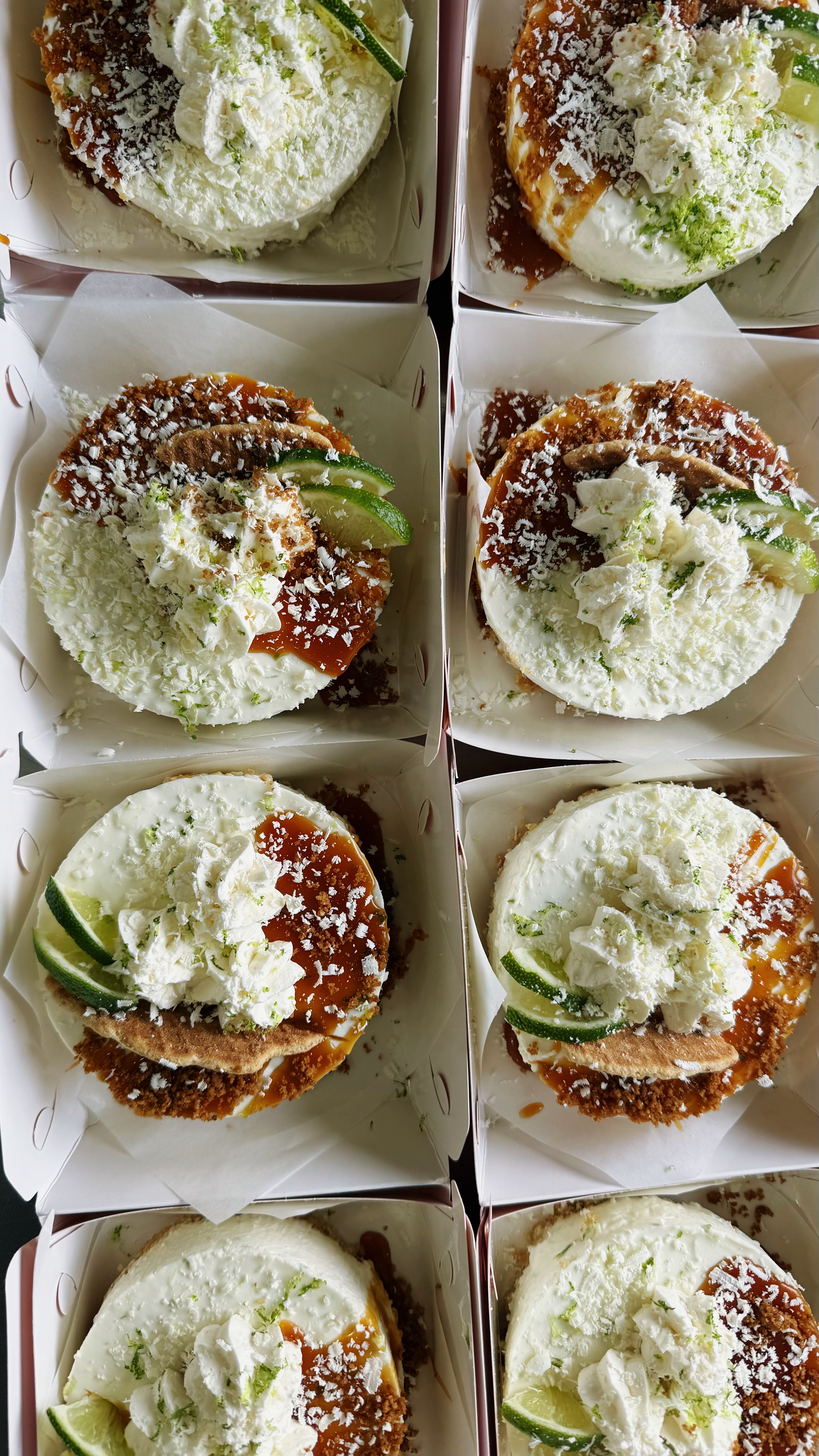 Finished CUKI treats in individual boxes with white toppings and lime slices