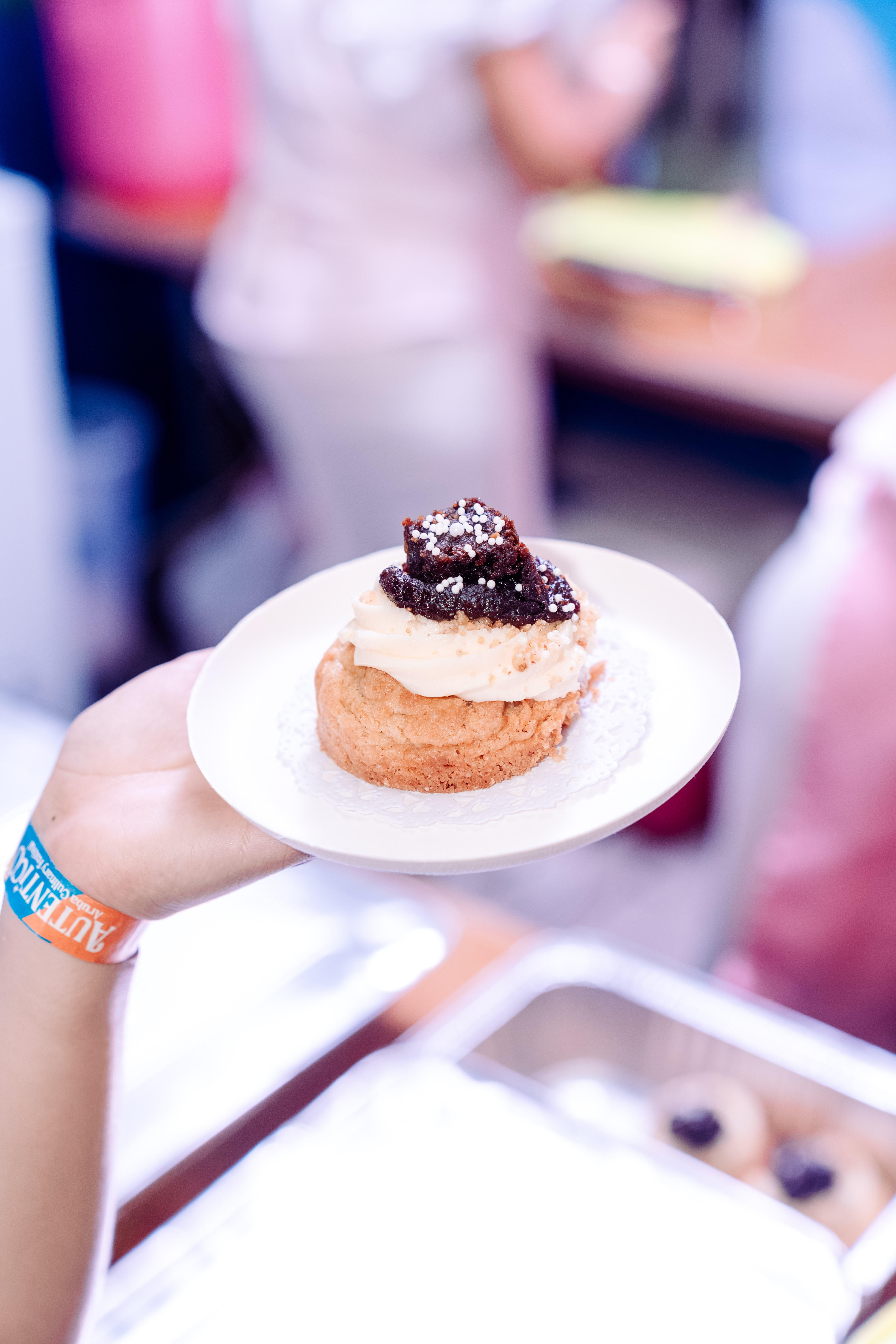A decorated cookie on a plate at a CUKI gathering