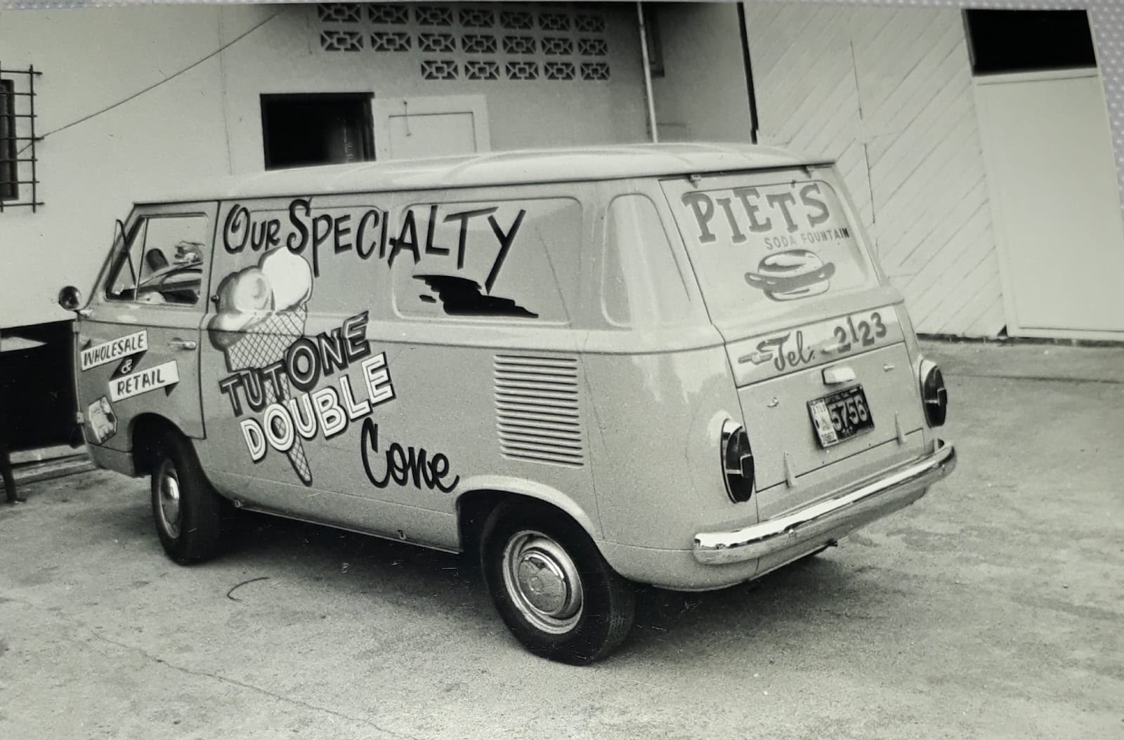 Archival black-and-white photograph of a van painted with Piet’s Soda Fountain and ice cream signs